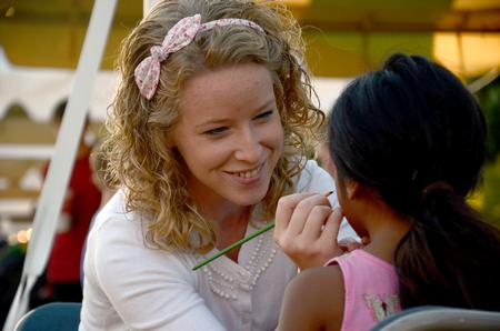 Bethany Kindt, sophomore art major and SAC member, paints faces in the SAC booth during Union Night. - Photo by Amanda Rohde