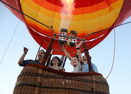 Fonsi Guilaran, left, associate professor of physics, goes up in a hot air balloon with wife Lesley Guilaran and family friend Nate Madison during Union Night on the Great Lawn. - Photo by Jacob Moore