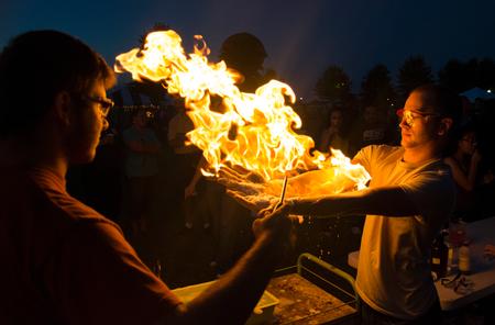 Nick Rivera, left, sophomore biology major, sets fires to propane bubbles held by Chance Maddox, sophomore biology major, to demonstrate a science experiment to guests of Union Night during Family Weekend.  - Photo by Jacob Moore