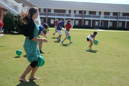 Nicole Bantz, sophomore biochemistry major, participates in one of the relays of Family Olympics in the Grace quad.  - Photo by Anne Richoux