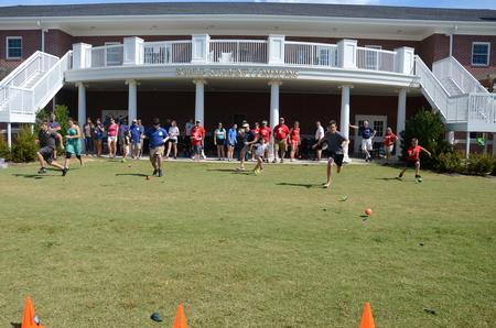 Students and their families run in a relay during Family Olympics in the Grace quad.  - Photo by Anne Richoux