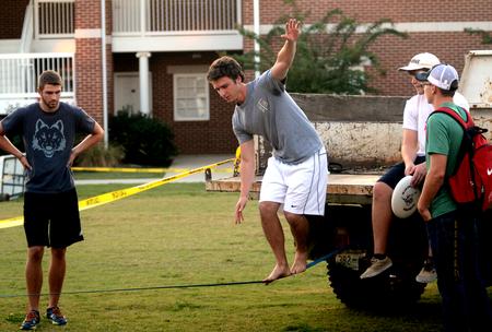 Participants attempt tightrope walking as one of the challenges for the Great Outdoors competition, which is an event for the men's quads hosted by Residence Life.  - Photo by Amanda Rohde