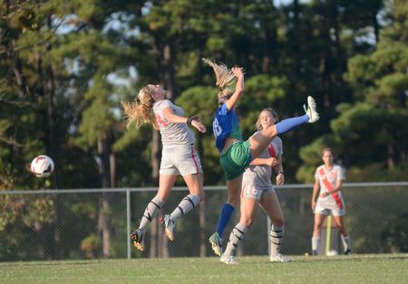 Lady Bulldog Rachael Boswell, senior athletic training major, heads the ball out of reach of University of West Florida players. - Photo by Amanda Rohde