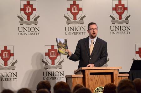 Justin Barnard, associate dean of the institute for intellectual discipleship and associate professor of philosophy, introduces Hal Poe, speaker for the Aslan's Apologist Town & Gown in the Carl Grant Events Center. - Photo by Anne Richoux
