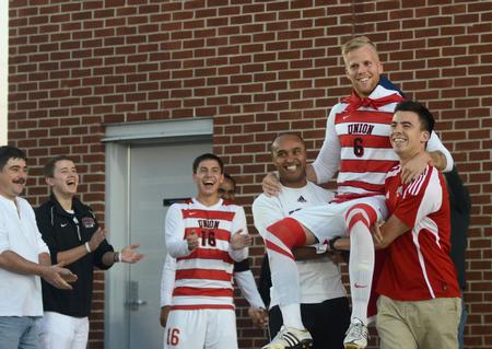 Bulldog Krister Andreassen is carried on field by fellow teammates during Senior Night. - Photo by Amanda Rohde