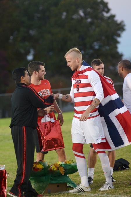 Bulldog Krister Andreassen shakes hands with head coach Clovis Simas during Senior Night.  - Photo by Amanda Rohde