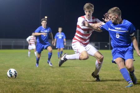 Bulldog Clayton Martin fights for possession of the ball during a home game against the University of Alabama at Huntsville. - Photo by Amanda Rohde