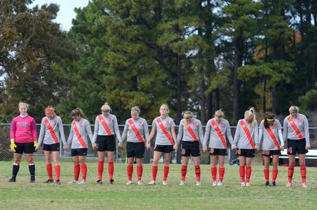The Lady Bulldogs bow their heads in prayer prior to their game against University of Alabama-Huntsville at the Smith Memorial Soccer Complex.  - Photo by Anne Richoux