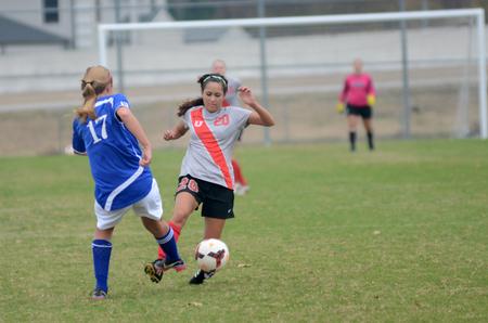 Lady Bulldog Sara Johnson, junior nursing major, dribbles around her opponent during a soccer game.  - Photo by Amanda Rohde