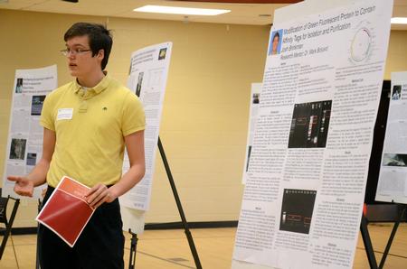Josh Brinkman, senior cell and molecular biology major, presents his research at the third annual Fall Poster Session in the Bowld Student Commons.  - Photo by Anne Richoux