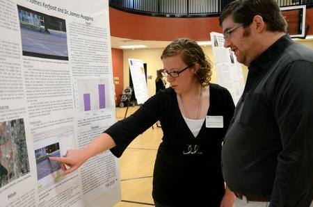 Chelsea Cothran, senior biology major with a concentration in zoology, talks with Chris LaFever about her research during the third annual Fall Poster Session. - Photo by Anne Richoux