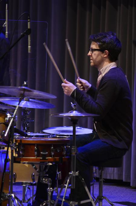 Aaron Beasley, graduate assistant to the Office of University Ministries, plays the drums during an opening song for chapel. - Photo by Jacob Moore