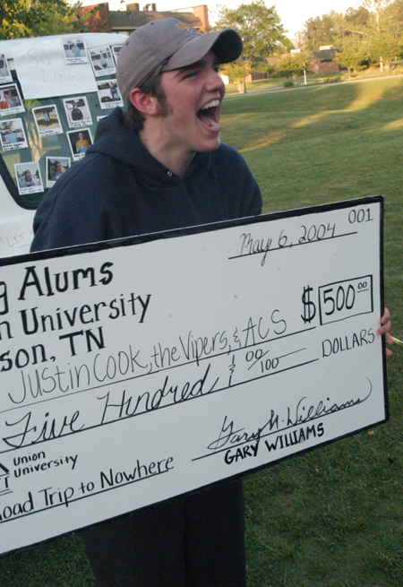 Freshman Justin Cook, philosophy major, celebrates his victory after staying for more than 28 hours in the Road Trip to Nowhere van. - Photo by Jonathan Blair