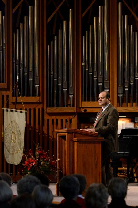 John Carbonell, associate vice president for human resources, speaks during the service of celebration and thanksgiving for David and Lanese Dockery.  - Photo by Anne Richoux