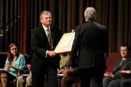 Walton Padelford, Porter Family Professor of business and economics, presents David S. Dockery, president of the university, with a gift as a part of a service of celebration and thanksgiving for the Dockerys.  - Photo by Anne Richoux