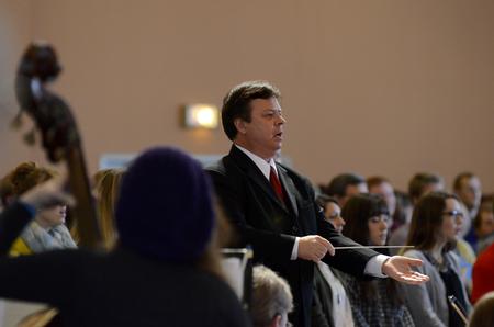Michael Mann, assistant professor of music, conducts the symphonic band at the close of the service of celebration and thanksgiving for David and Lanese Dockery. - Photo by Anne Richoux