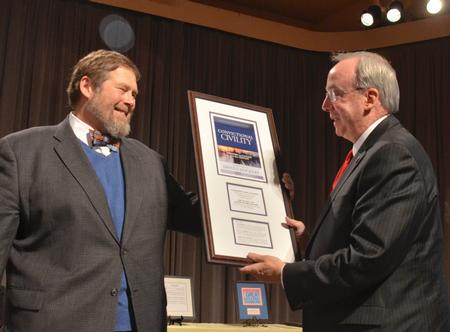 Ben Mitchell, Graves Professor of Moral Philosophy, presents the award of Convictional Civility given to David S. Dockery during the service of celebration and thanksgiving for David and Lanese Dockery. - Photo by Morris Abernathy