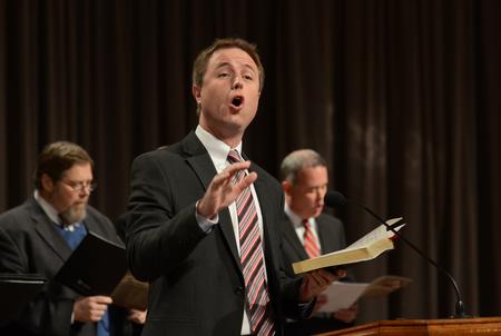 Chris Mathews, department chair of music, leads a hymn during a service of celebration and thanksgiving for David and Lanese Dockery in the G.M. Savage Memorial Chapel. - Photo by Jacob Moore