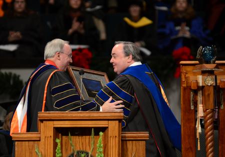 David S. Dockery, president of the university, presents J. Michael Duduit, commencement speaker and dean of the College of Christian Studies at Anderson University, with the Robert E. Craig Service Award during Fall Commencement Services. - Photo by Jacob Moore