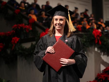 Kristen Fite, nursing graduate, walks back to her seat after receiving her diploma during the Fall Commencement Services at West Jackson Baptist Church. - Photo by Matt McDaniel
