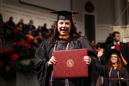 Amy Little, masters of nursing graduate, walks back to her seat after receiving her diploma during the Fall Commencement Services. - Photo by Matt McDaniel