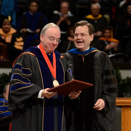 David S. Dockery, president of the university, receives an honorary doctorate of letters from the College of Arts and Sciences during Fall Commencement Services. - Photo by Jacob Moore