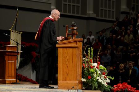 Steve Beverly, associate professor of communication arts, reads scripture as a part of Fall Commencement Services at West Jackson Baptist Church.  - Photo by Anne Richoux