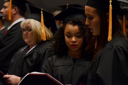 Graduates sing the alma mater at the end of Fall Commencement Services at West Jackson Baptist Church.  - Photo by Anne Richoux