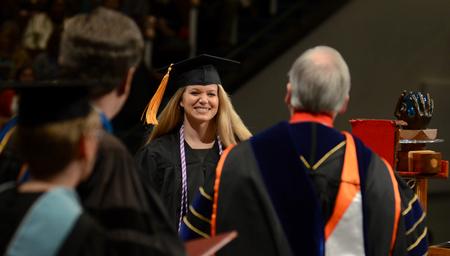 Lindsey Lowrie, nursing graduate, accepts her diploma during Fall Commencement Services.  - Photo by Jacob Moore
