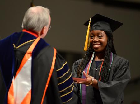 Chelsea Nappier, psychology graduate, receives her diploma during Fall Commencement Services at West Jackson Baptist Church. - Photo by Jacob Moore