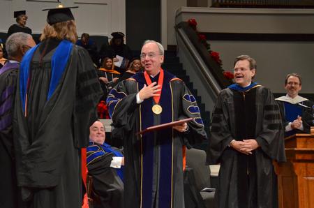 David S. Dockery, president of the university, is moved by the presentation of the Doctor of Letters by the College of Arts and Sciences during Fall Commencement Services. - Photo by Morris Abernathy