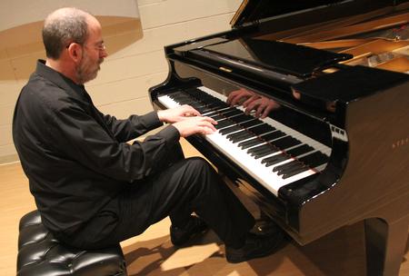 Terry McRoberts, university professor of music, performs during his faculty piano recital. - Photo by Matt McDaniel