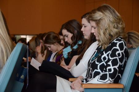 The ladies of Zeta Tau Alpha join in prayer during the chapel in remembrance of Olivia Greenlee. - Photo by Matt McDaniel