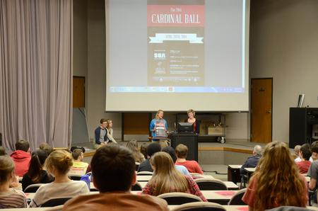 Morgan Kroeger, junior accounting and spanish double major, announces details about the upcoming Cardinal Ball during a Student Senate meeting in Harvey Auditorium. - Photo by MiKalla Cotton