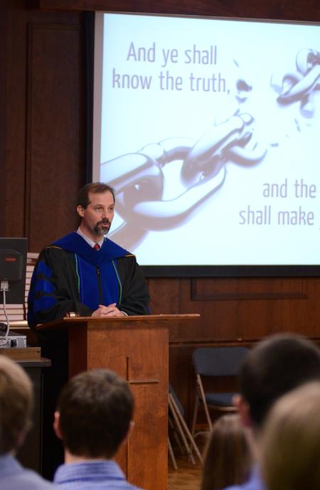 Sean Evans, associate professor and chair of the department of political science, begins the induction ceremony for the Union chapter of the Alpha Chi honor society.  - Photo by Anne Richoux