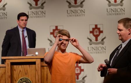 Quinten Brasher, freshman history major, adjusts Google Glass to fit his face shape during the Thomas R. Rosebrough Center for Educational Practice event focused on uses of Google Glass in education. - Photo by Jacob Moore