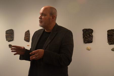 Chris Nadaskay, university professor of art, answers questions about his exhibit, "Of Moths and Rust" at the opening reception in the Union art gallery.  - Photo by Anne Richoux