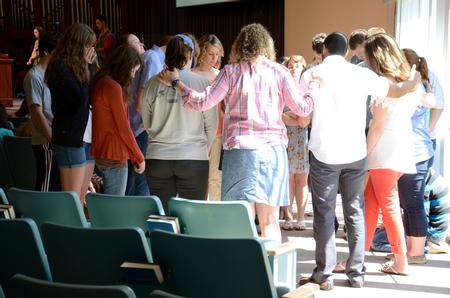 Students headed to do missions this summer are prayed over by staff after the GO Trip report chapel. - Photo by MiKalla Cotton