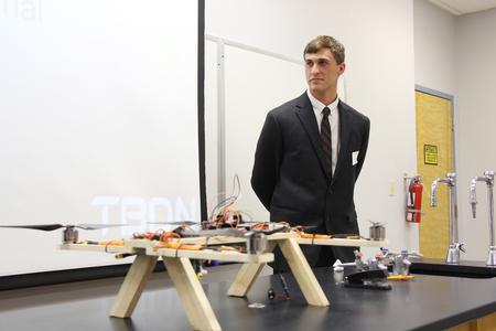 Kenneth Mayo, senior engineering major, stands behind the GoPro drone that his group made for the Scholarship Symposium. - Photo by Matt McDaniel