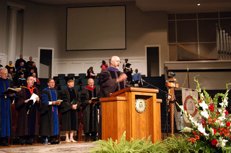 Dr. Richard Joiner, music department chair, leads in singing of the Union University Alma Mater at the August graduation service at West Jackson Baptist Church. - Photo by Morris Abernathy