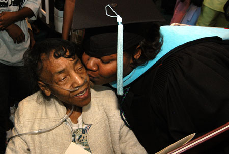Richelle D. Jones of Memphis, Tenn., kisses her grandmother after receiving her master of education degree during August commencement services at West Jackson Baptist Church. - Photo by Morris Abernathy
