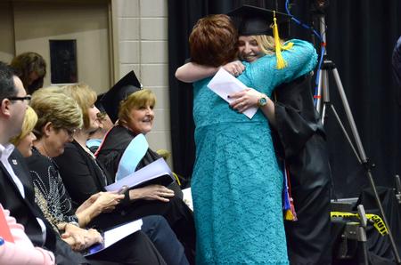The Tigrett Medal Winner of 2014, Grace Morriss, graduate with a bachelor of science in electrical engineering, receives her award and hugs a faculty member in celebration at the Spring Commencement Services. - Photo by MiKalla Cotton