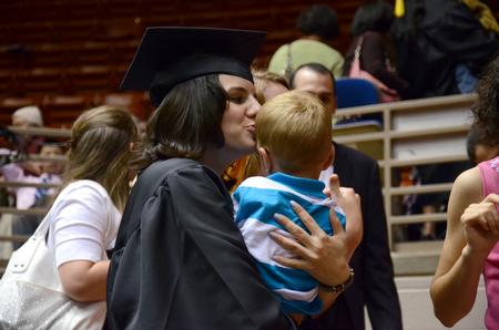 Deborah Anderson, nursing graduate, holds her nephew following Spring Commencement Services at the Oman Arena. - Photo by MiKalla Cotton