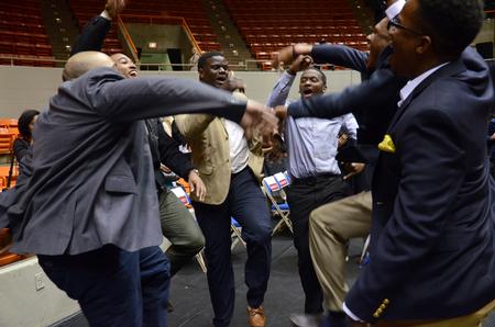 Members of Alpha Phi Alpha celebrate with a fraternal hymn following the Spring Commencement Services. - Photo by MiKalla Cotton