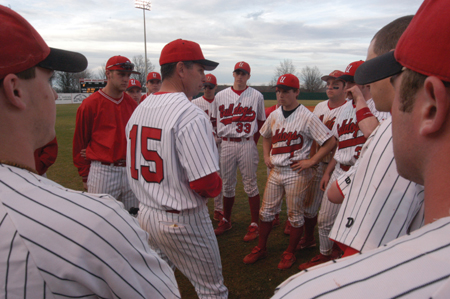 Head Coach Andy Rushing gave the team a pep talk between double header games. - Photo by Jonathan Blair