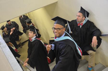 Master's degree graduates anxiously await the start of the Spring Commencement Services the Oman Arena. - Photo by Emily Stookey
