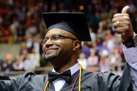 Marcus Johnson, bachelor of science in organizational leadership graduate, gives a thumbs up to his family and friends as they watch he and 629 others prepare to receive degrees at Union University's 189th Spring Commencement. - Photo by Kathleen Murray