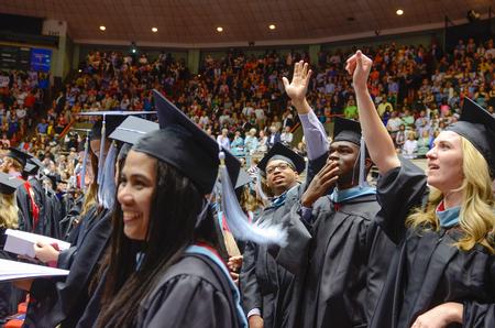 Graduates search for and wave at family and friends who gather to watch the 630 students graduate at Union University's 189th Spring Commencement. - Photo by Kathleen Murray