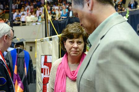 The parents of Olivia Greenlee, music education, share a moment after receiving their daughter's posthumous degree during the Spring Commencement Services. - Photo by Kathleen Murray