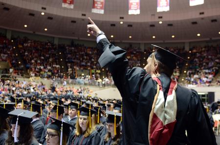 Christopher Eldridge, masters of business administration graduate, sends a greeting to friends and family after receiving his degree during Spring Commencement Services. - Photo by Kathleen Murray